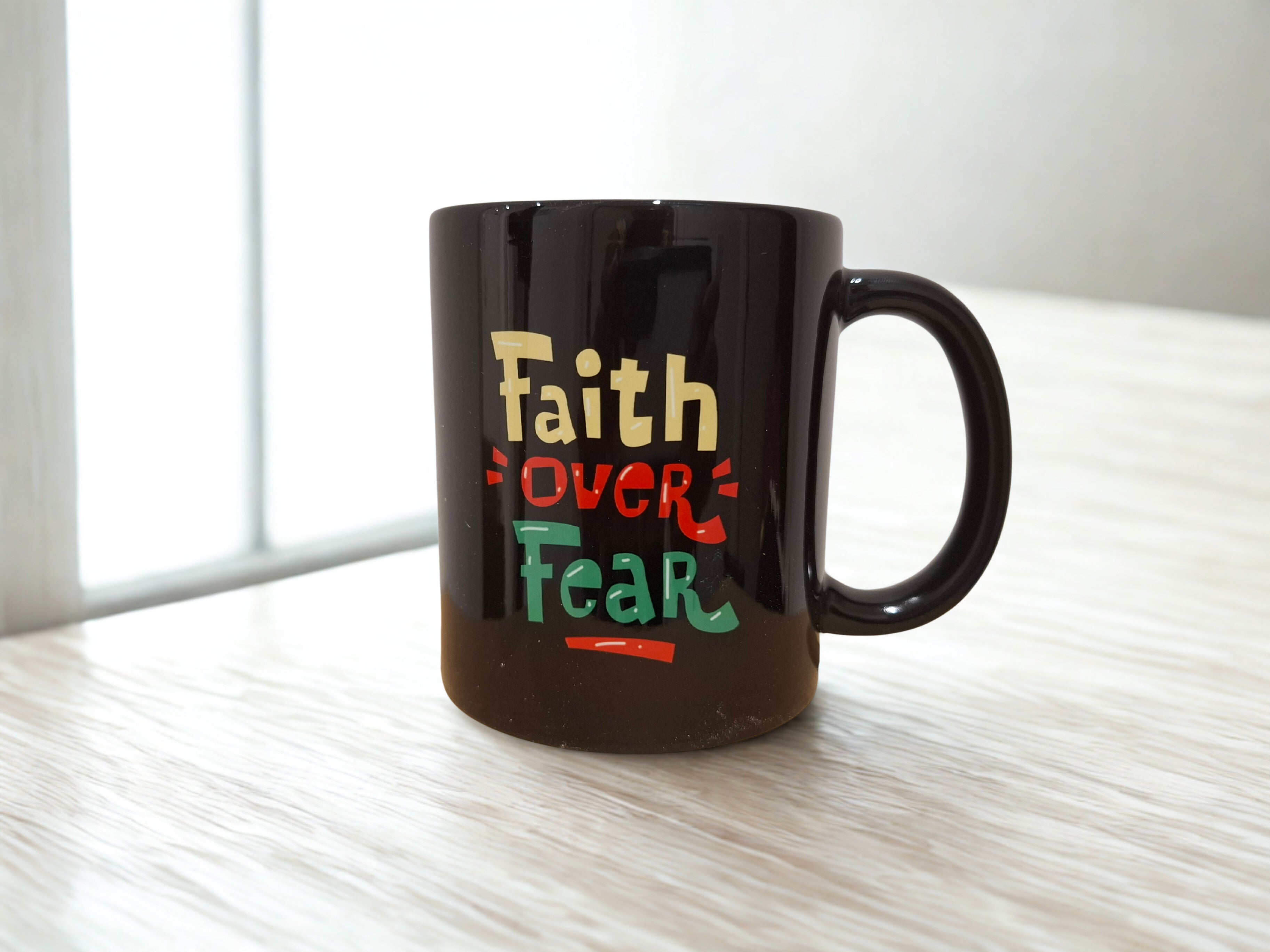 Faith over fear black mug
